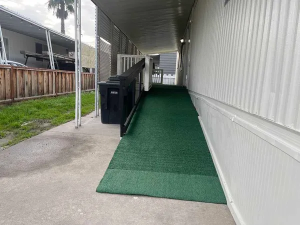 a view of a backyard with wooden fence