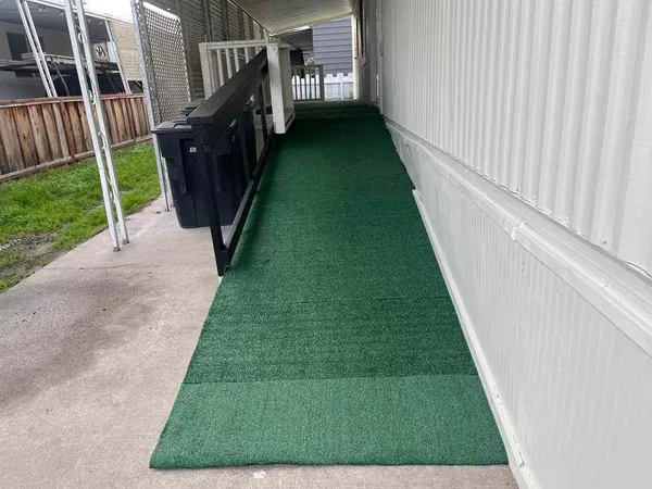 a view of a backyard with wooden fence