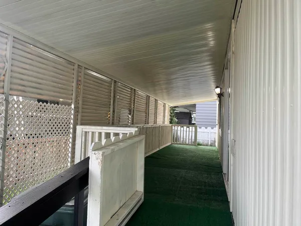 a view of a porch with wooden floor