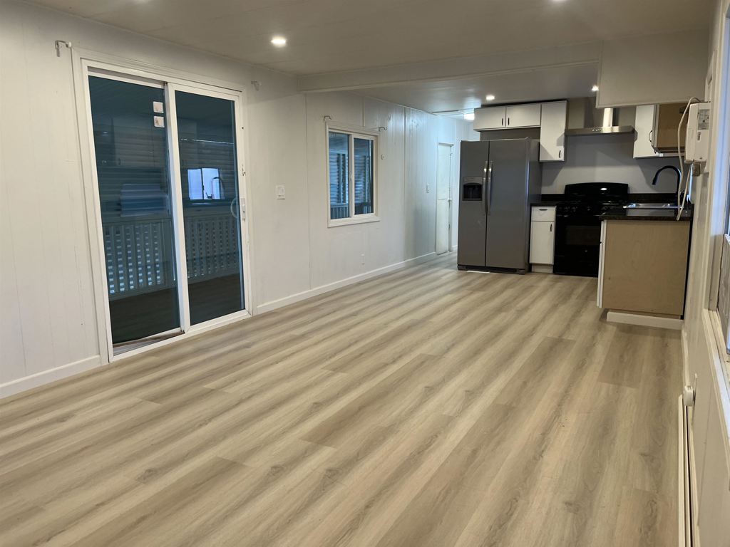 4143 Yosemite Boulevard Modesto, CA 95357 - Photo 22 of 22 a view of a kitchen with refrigerator and wooden floor