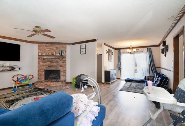 a living room with furniture fireplace and flat screen tv