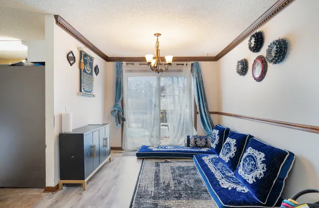 a view of a hallway with wooden floor and stairs