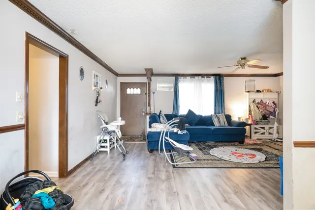 a living room with furniture and wooden floor