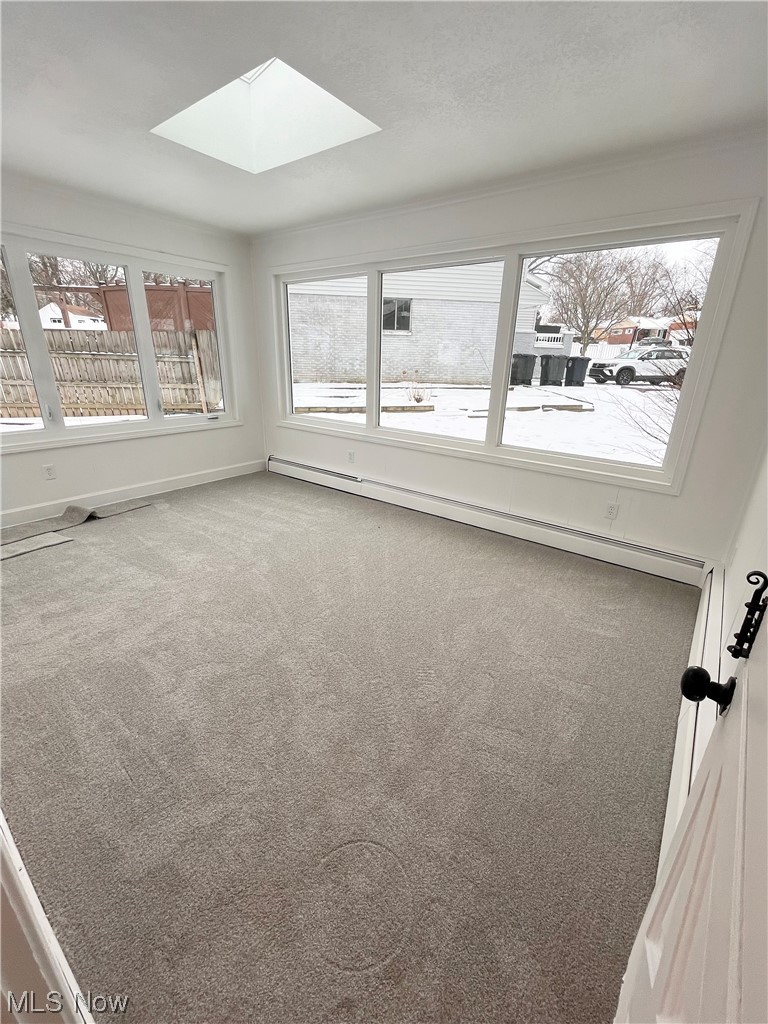 305 Tremont Road Akron, OH 44313 - Photo 23 of 25 Carpeted spare room with a baseboard radiator and a skylight