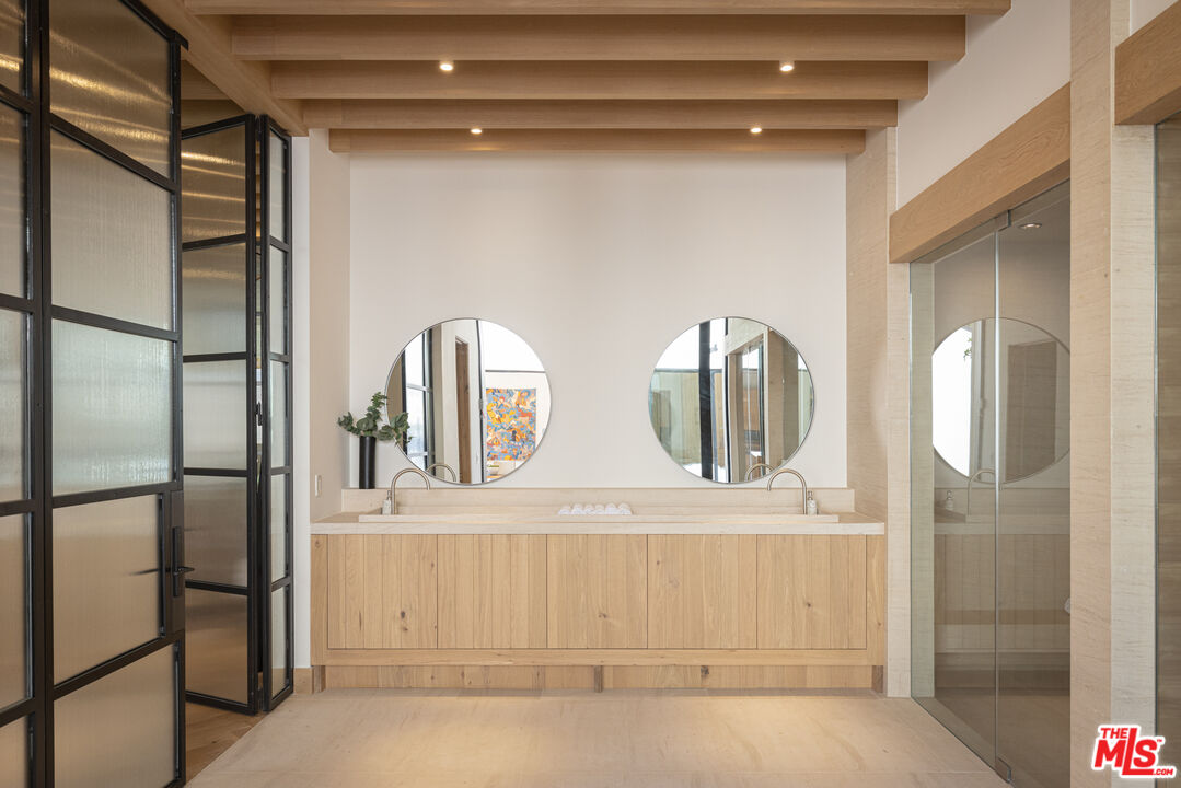 16036 Woodvale Road Encino, CA 91436 - Photo 18 of 54 a bathroom with a double vanity sink