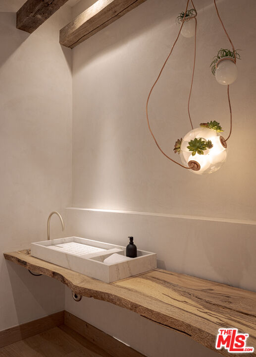 16036 Woodvale Road Encino, CA 91436 - Photo 22 of 54 a bathroom with a sink and a mirror