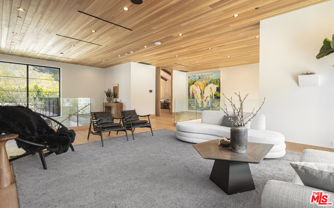 16036 Woodvale Road Encino, CA 91436 - Photo 26 of 54 a living room with furniture and a large window