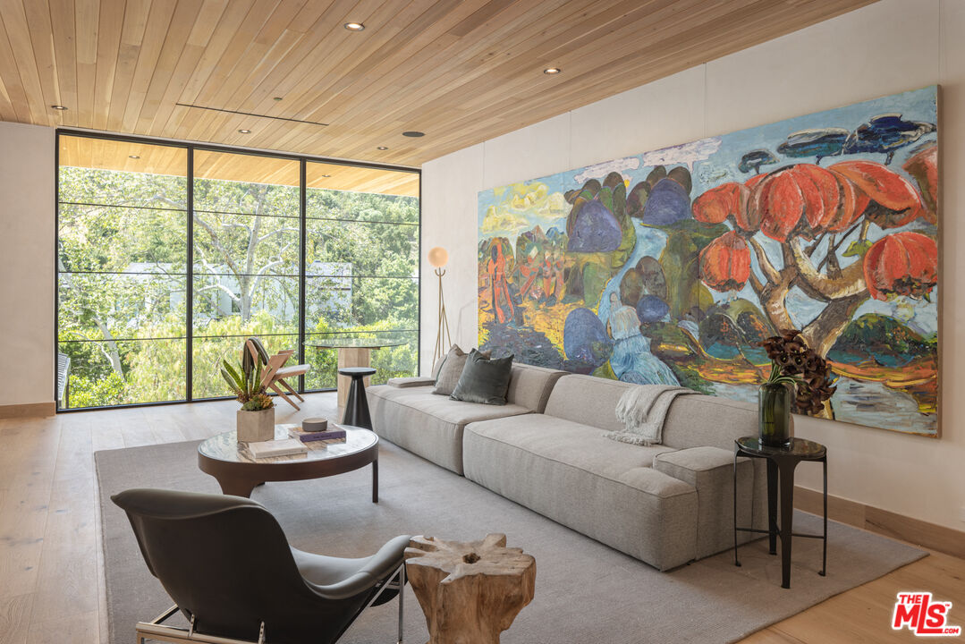 16036 Woodvale Road Encino, CA 91436 - Photo 30 of 54 a living room with furniture and a large window