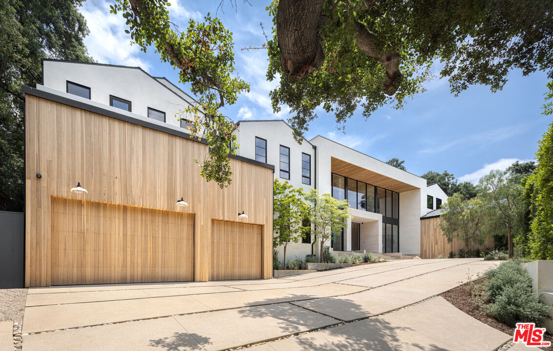 16036 Woodvale Road Encino, CA 91436 - Photo 3 of 54 a front view of a house with a garden
