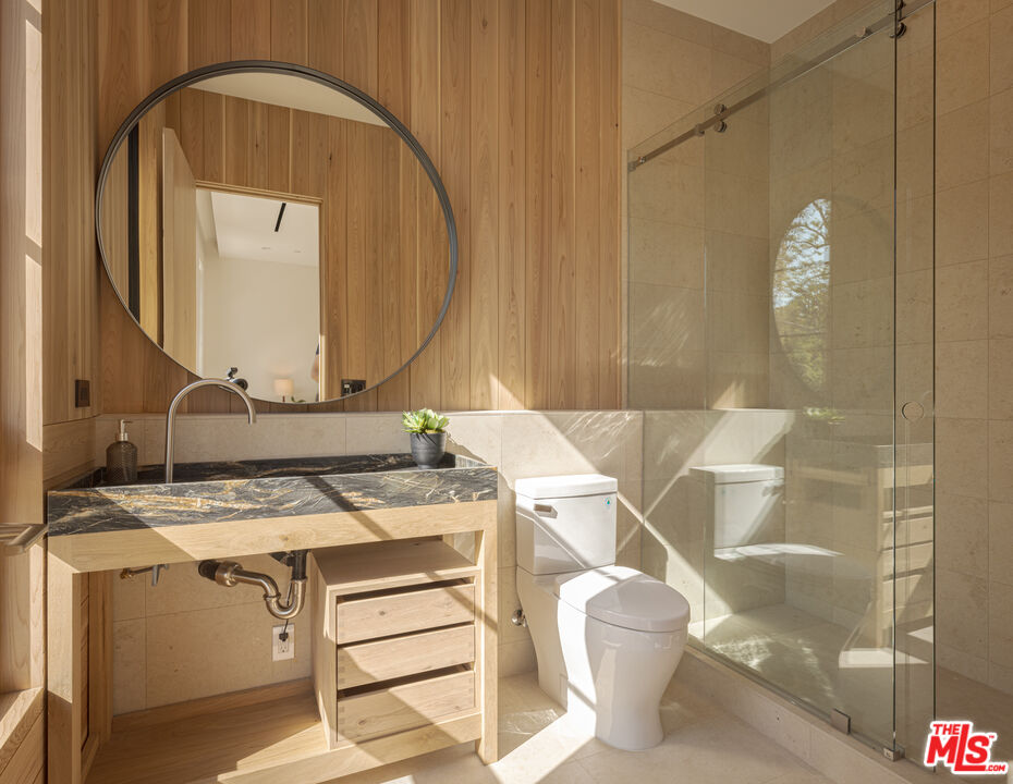 16036 Woodvale Road Encino, CA 91436 - Photo 35 of 54 a bathroom with a sink and a mirror