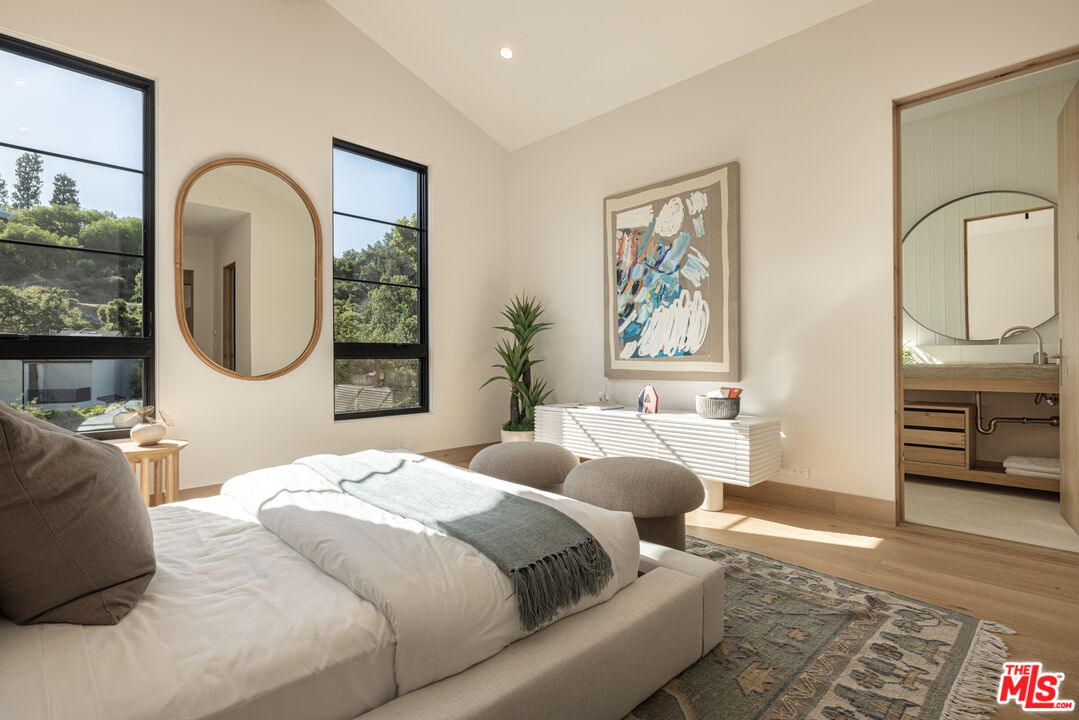 16036 Woodvale Road Encino, CA 91436 - Photo 38 of 54 a bedroom with bed and a mirror