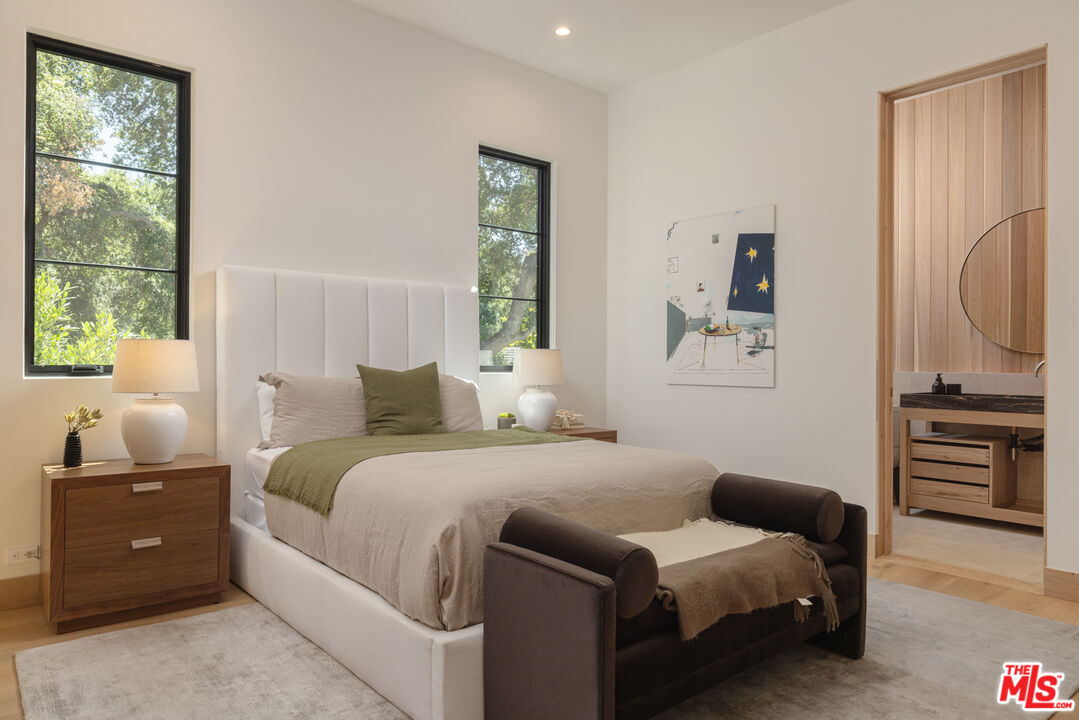 16036 Woodvale Road Encino, CA 91436 - Photo 39 of 54 a bedroom with a bed and a television