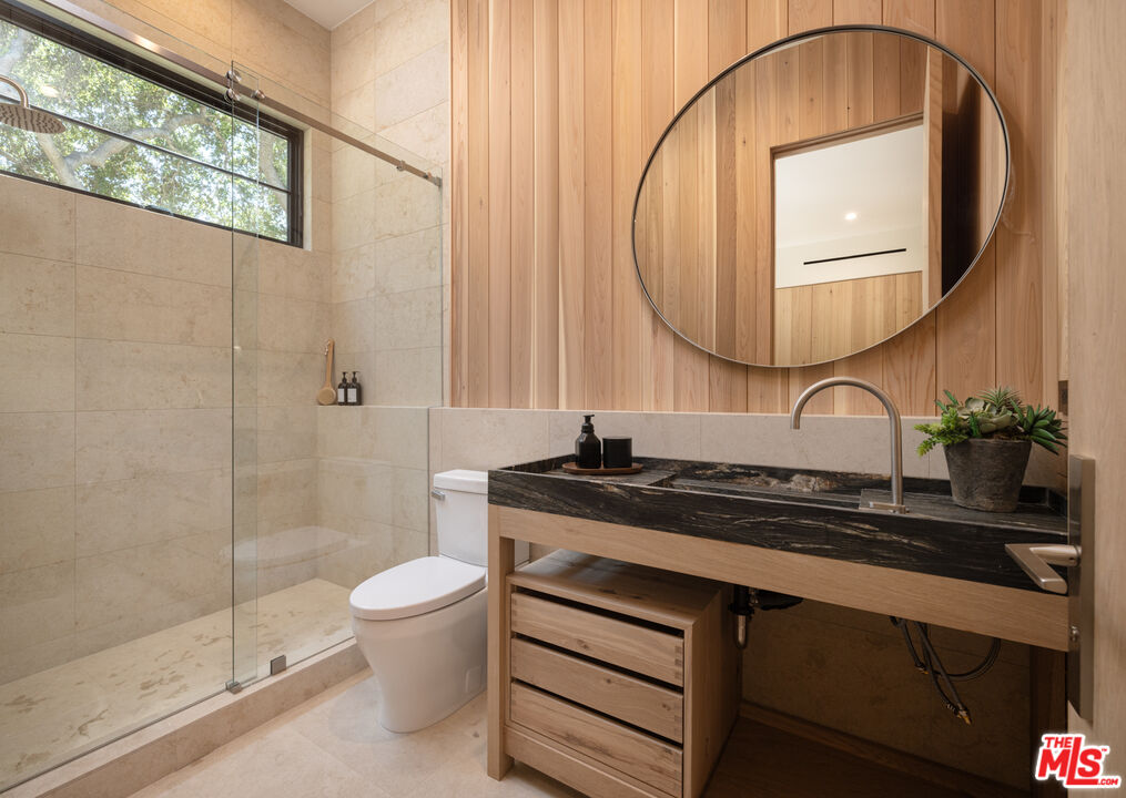 16036 Woodvale Road Encino, CA 91436 - Photo 40 of 54 a bathroom with a sink a toilet and a mirror
