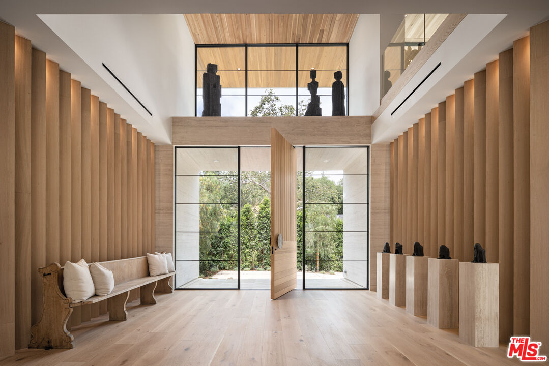 16036 Woodvale Road Encino, CA 91436 - Photo 4 of 54 a view of front door with furniture and wooden floor