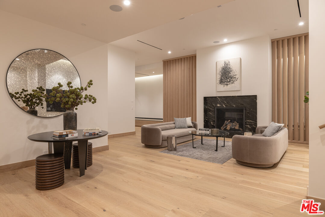 16036 Woodvale Road Encino, CA 91436 - Photo 41 of 54 a living room with furniture and a fireplace