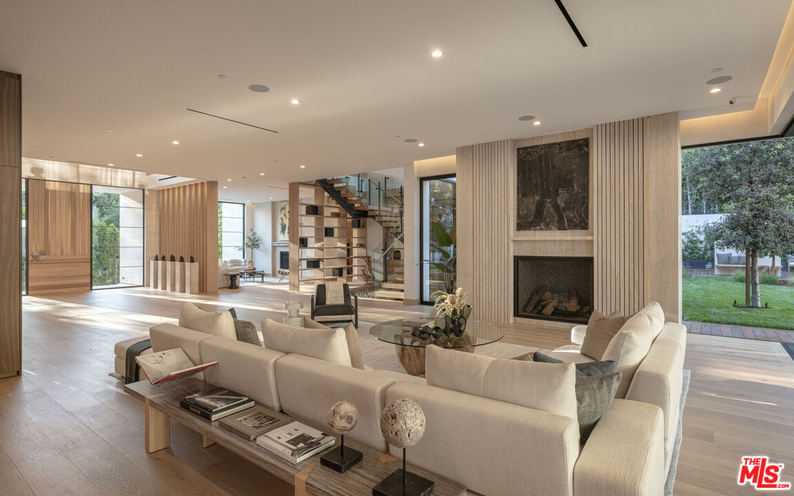 16036 Woodvale Road Encino, CA 91436 - Photo 7 of 54 a living room with furniture and a fireplace