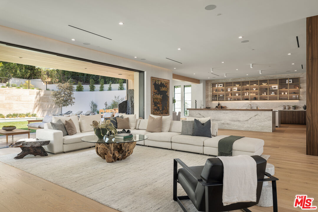 16036 Woodvale Road Encino, CA 91436 - Photo 8 of 54 a living room with furniture and a large window