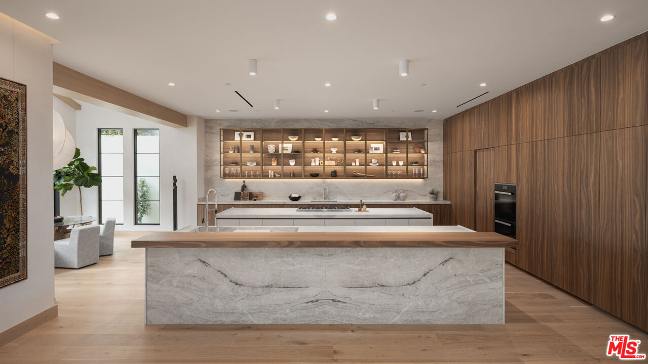 16036 Woodvale Road Encino, CA 91436 - Photo 9 of 54 a large room with a large window and furniture