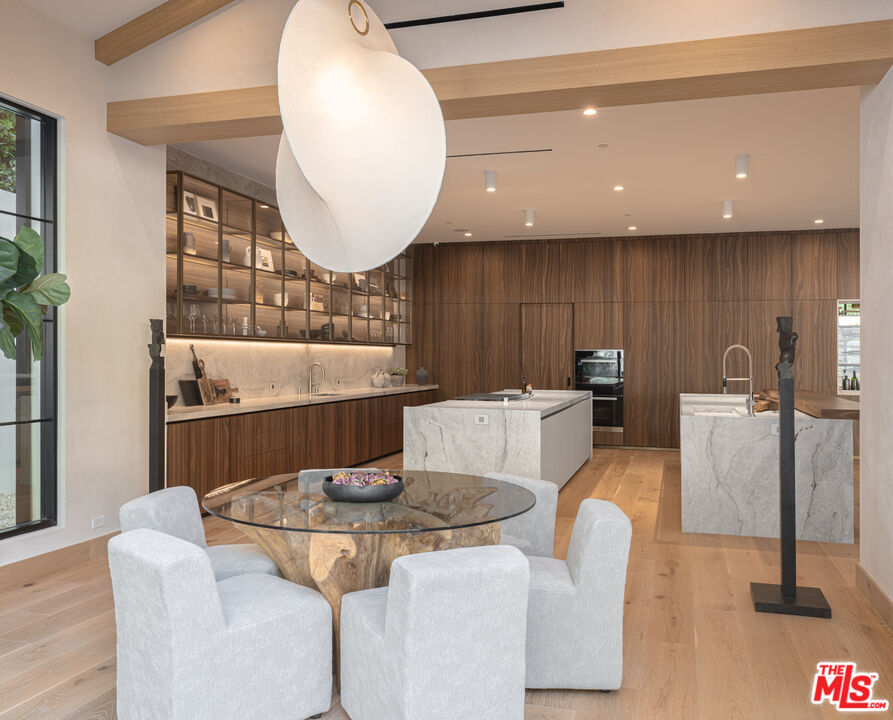 16036 Woodvale Road Encino, CA 91436 - Photo 10 of 54 a kitchen with a table and chairs