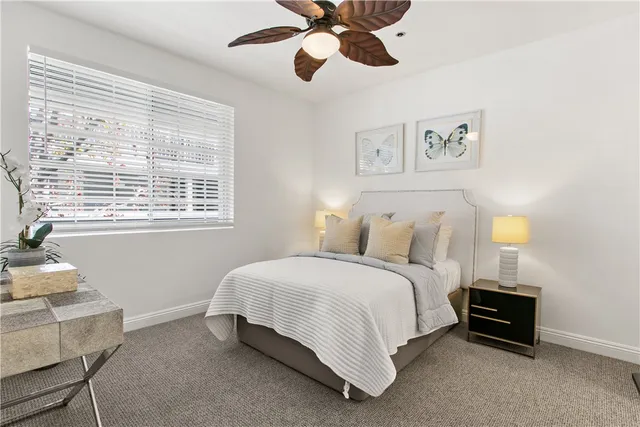 a spacious bedroom with a bed and a window