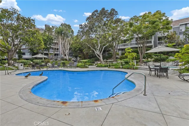a view of a swimming pool with outdoor seating