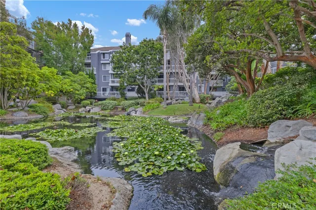 a view of a garden with a building in back