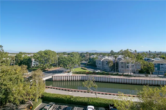 a view of a field with an trees in the background