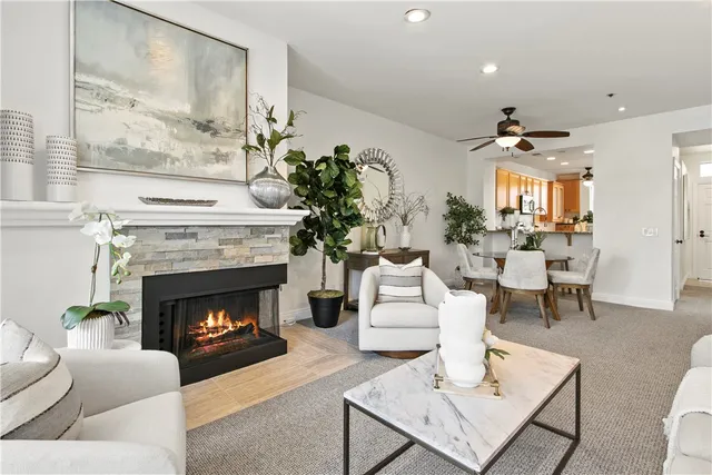 a living room with furniture a fireplace and a large mirror