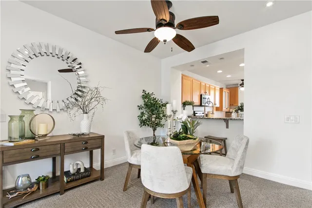 a dining room with furniture a chandelier and wooden floor