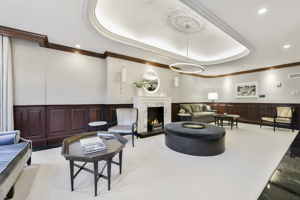 390 Commonwealth Avenue, Unit 305 Boston, MA 02215 - Photo 21 of 23 a living room with furniture a fireplace and kitchen view