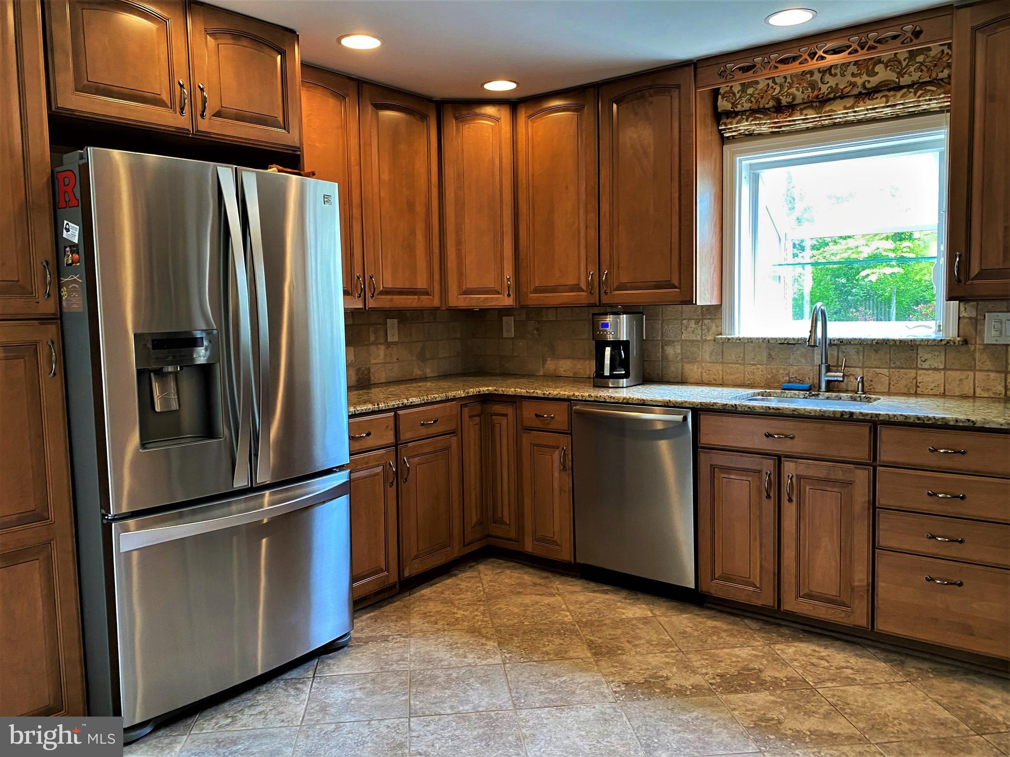 555 Tarrington Road Cherry Hill, NJ 08034 - Photo 11 of 19 a kitchen with granite countertop stainless steel appliances a refrigerator sink and microwave