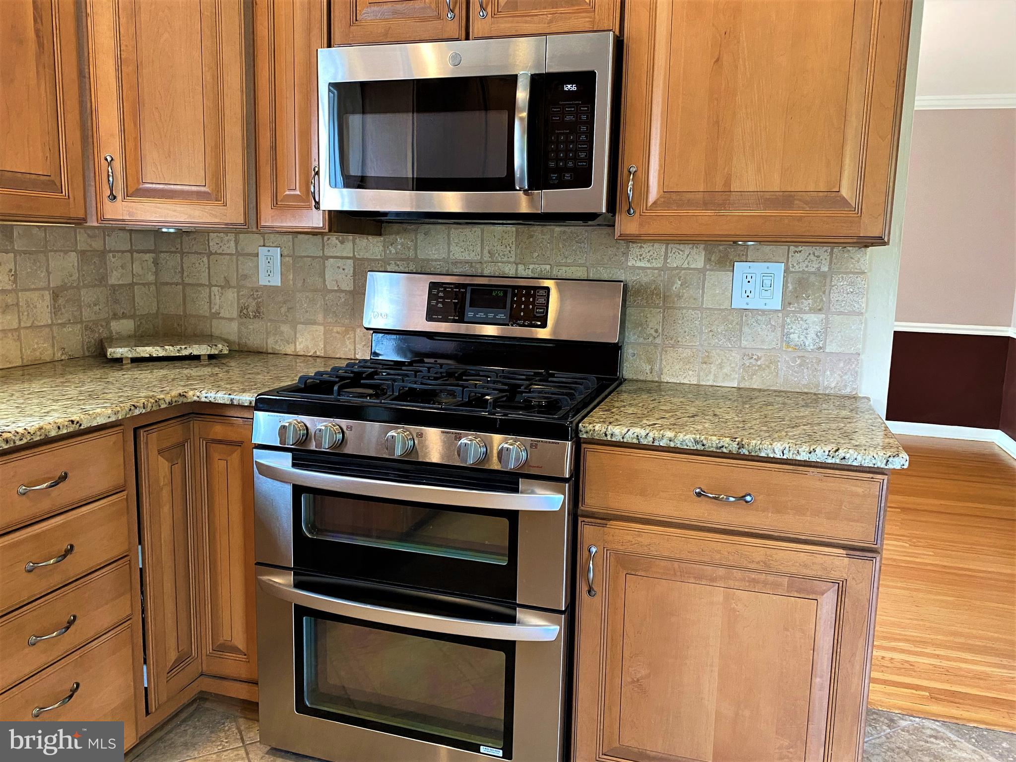 555 Tarrington Road Cherry Hill, NJ 08034 - Photo 13 of 19 a kitchen with granite countertop a stove and a microwave