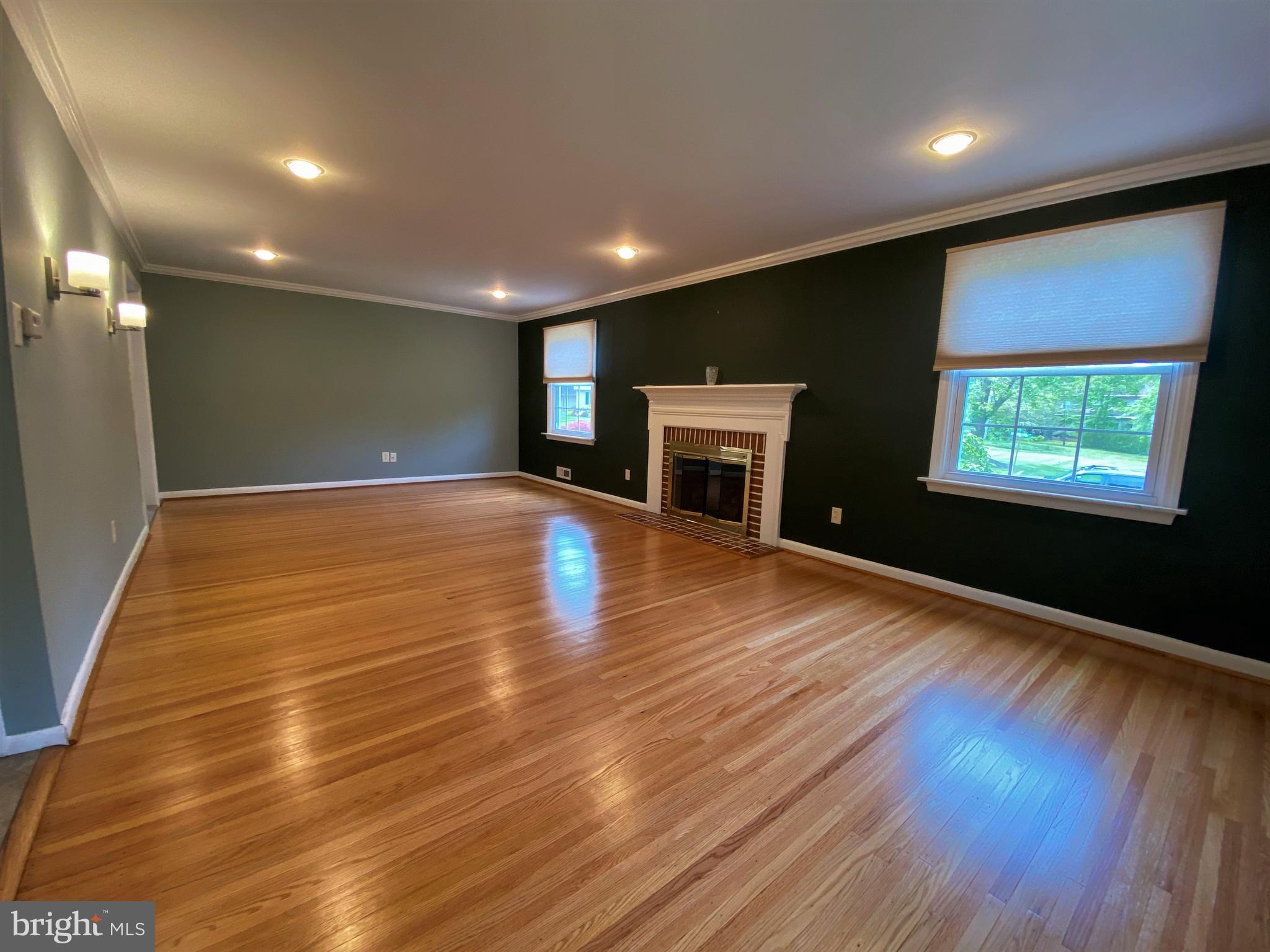 555 Tarrington Road Cherry Hill, NJ 08034 - Photo 9 of 19 a view of an empty room with wooden floor and a kitchen