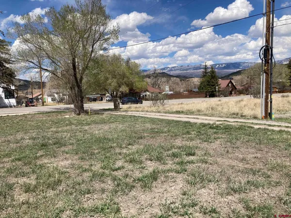 a view of a yard with wooden fence