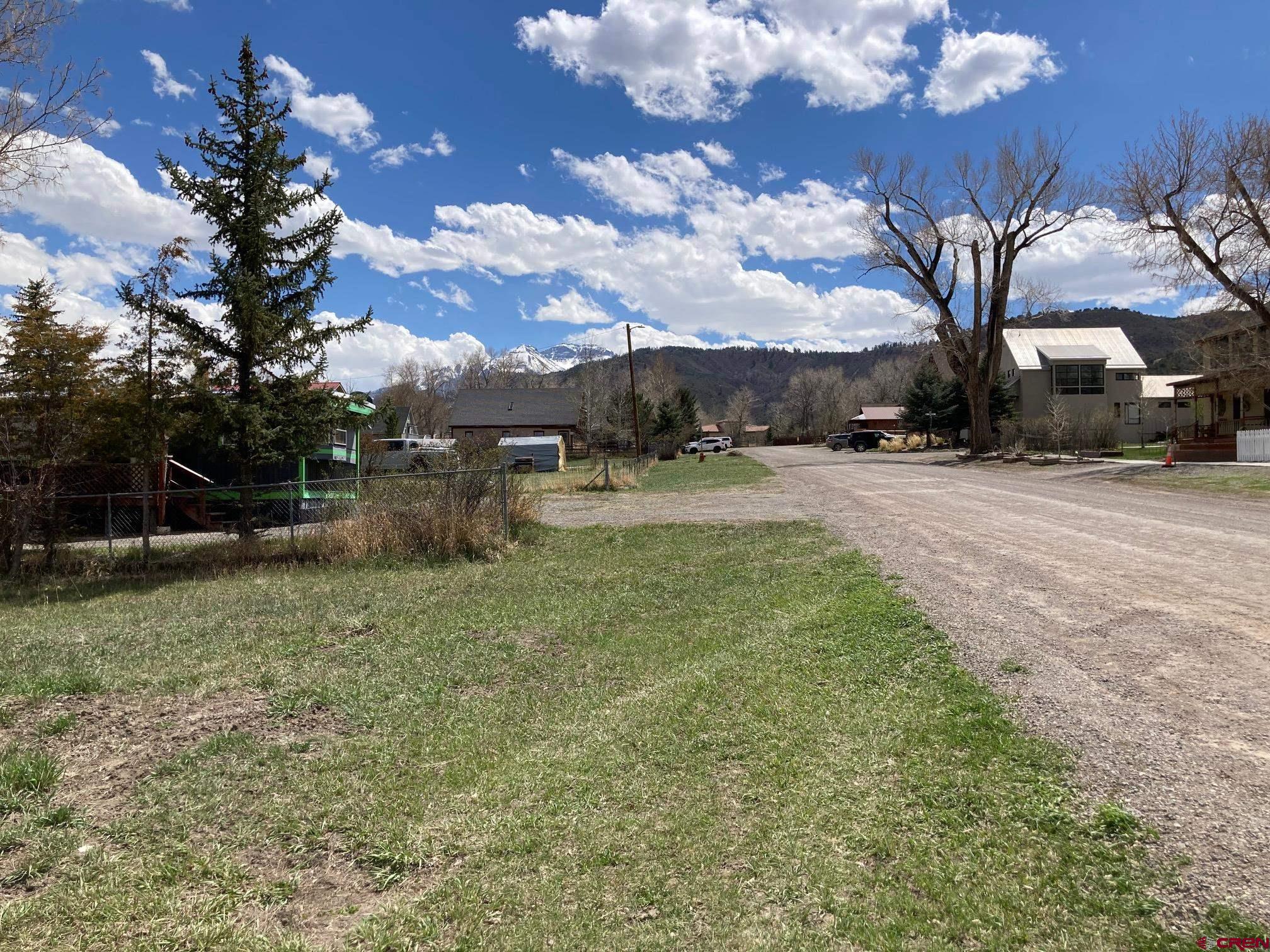 134 South Charlotte Street Ridgway, CO 81432 - Photo 18 of 23 a view of a yard with a house in the background