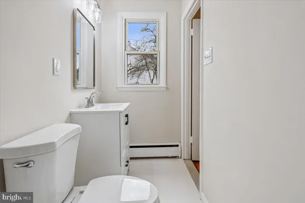 a bathroom with a sink a toilet and mirror
