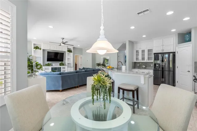 a kitchen with stainless steel appliances granite countertop a refrigerator stove and sink
