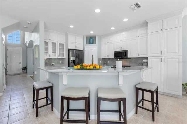 a dining room with furniture a chandelier and wooden floor
