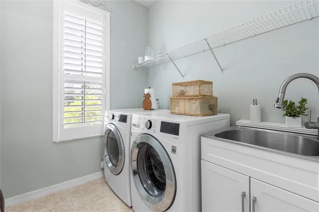 a living room with furniture a chandelier and a painting
