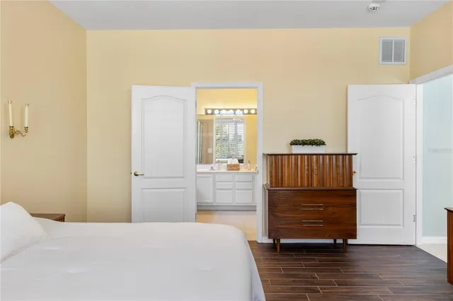 a spacious bathroom with a granite countertop sink a toilet and a large mirror