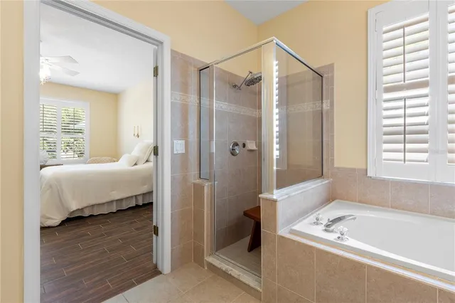 a spacious bedroom with a bed and a chandelier