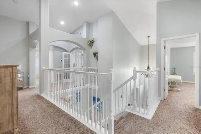 a spacious bedroom with a bed and a chandelier