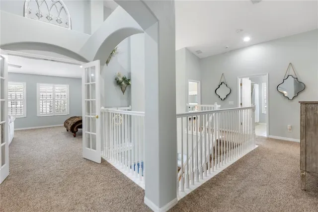 a bedroom with a bed and a ceiling fan