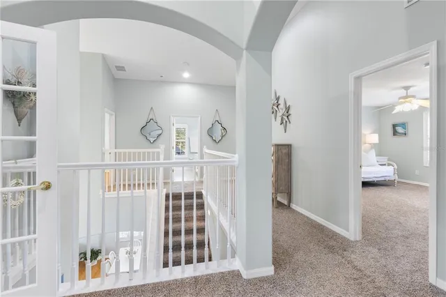 a bedroom with two beds and a chandelier