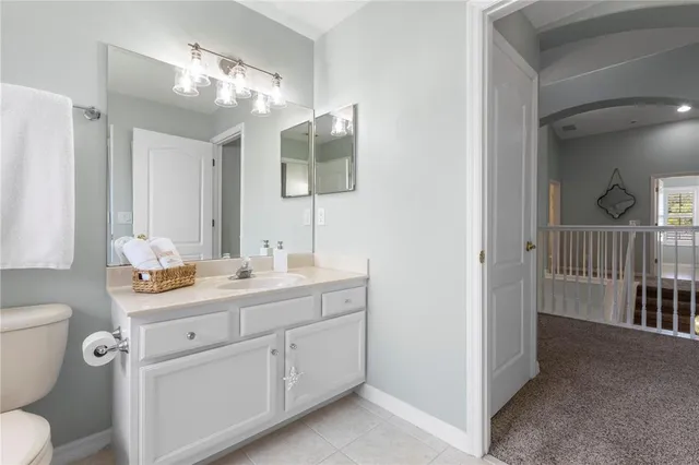 an aerial view of a house with a yard and large trees