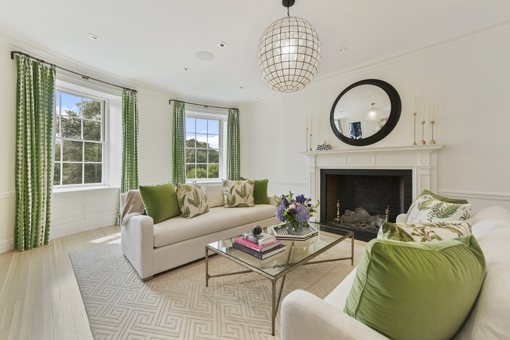 a living room with furniture a rug and a fireplace