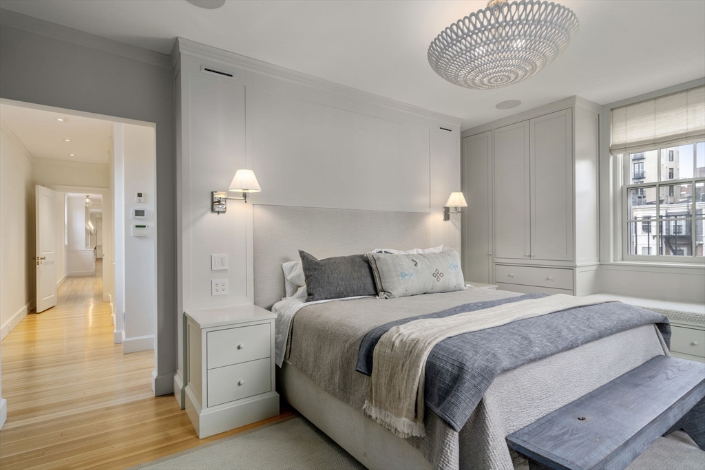 62 Beacon Street, Unit 3 Boston, MA 02108 - Photo 17 of 25 a bedroom with a bed and a chandelier