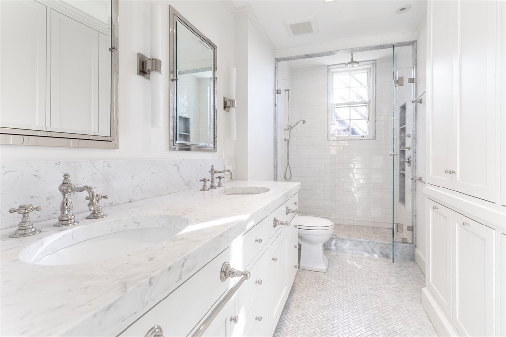 62 Beacon Street, Unit 3 Boston, MA 02108 - Photo 18 of 25 a bathroom with a double vanity sink toilet and shower