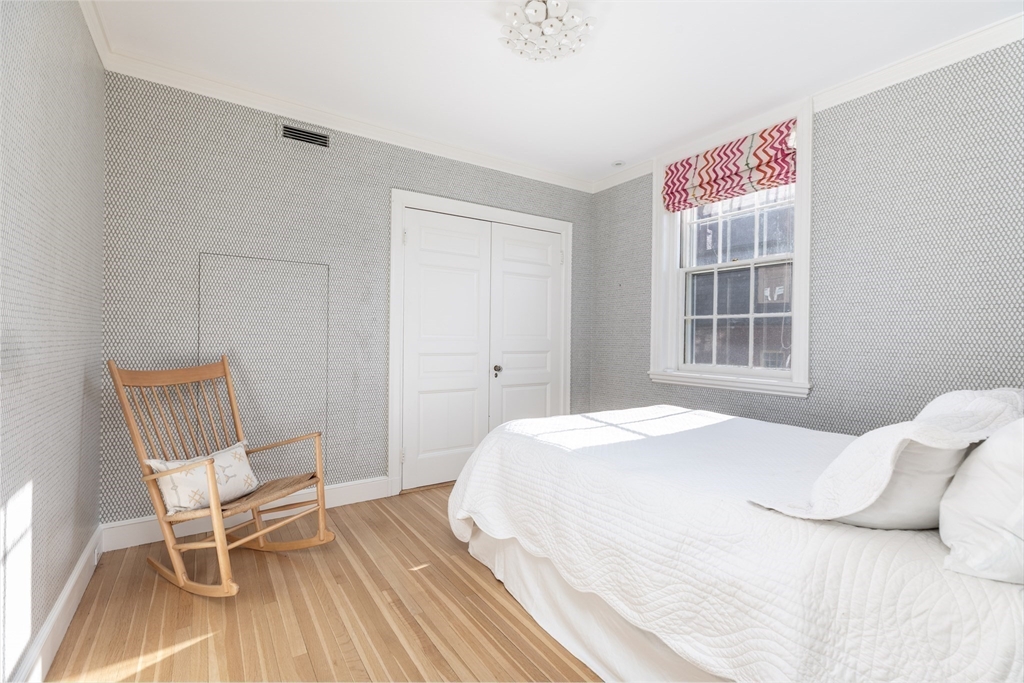 62 Beacon Street, Unit 3 Boston, MA 02108 - Photo 19 of 25 a bedroom with a bed and a chair