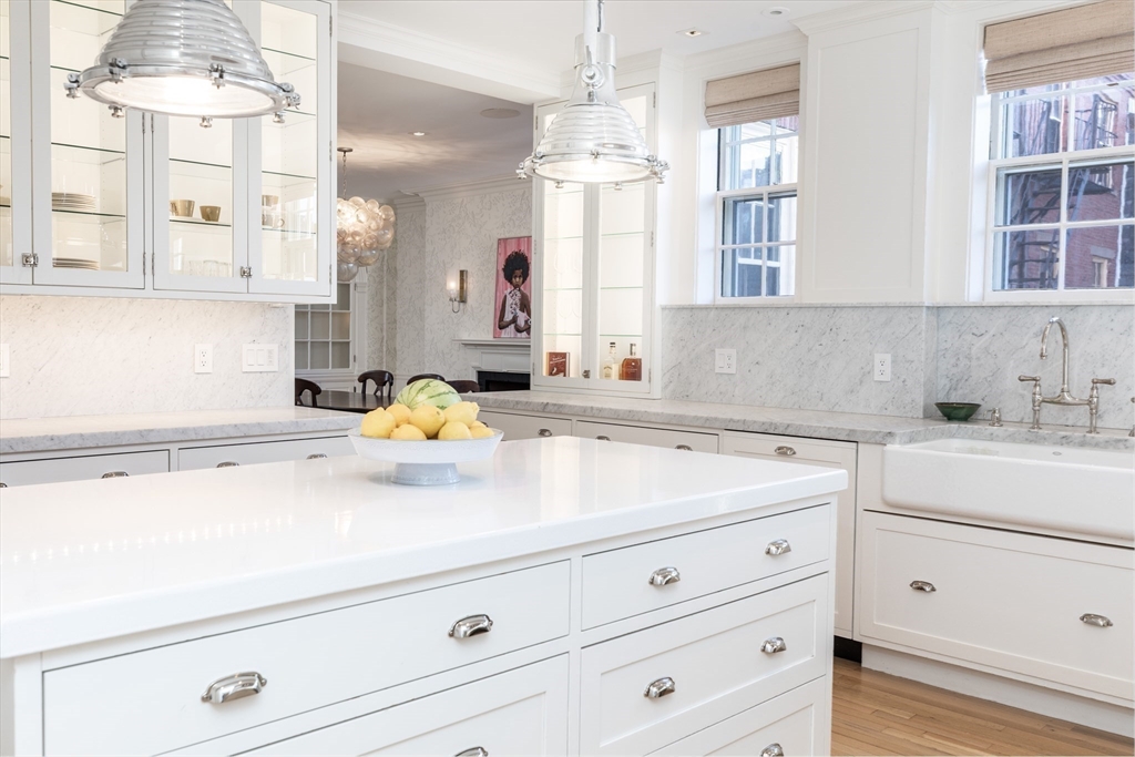 62 Beacon Street, Unit 3 Boston, MA 02108 - Photo 7 of 25 a kitchen with a sink cabinets and window